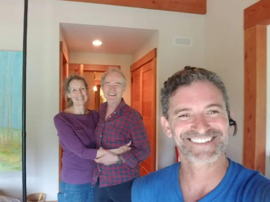 Two happy customers with their Moving Pro Inc mover after a completed move