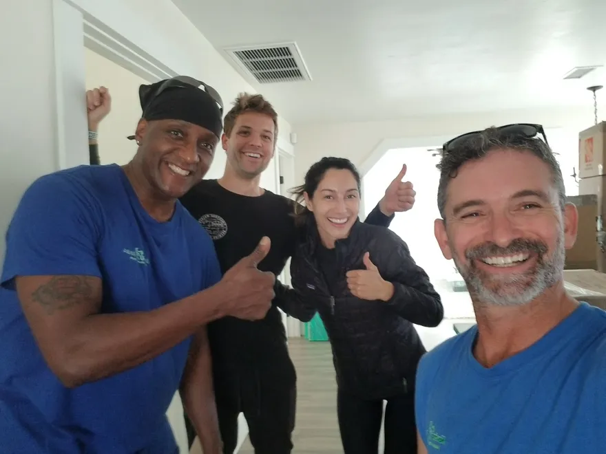 Customers and the Moving Pro Inc crew giving thumbs up on move day